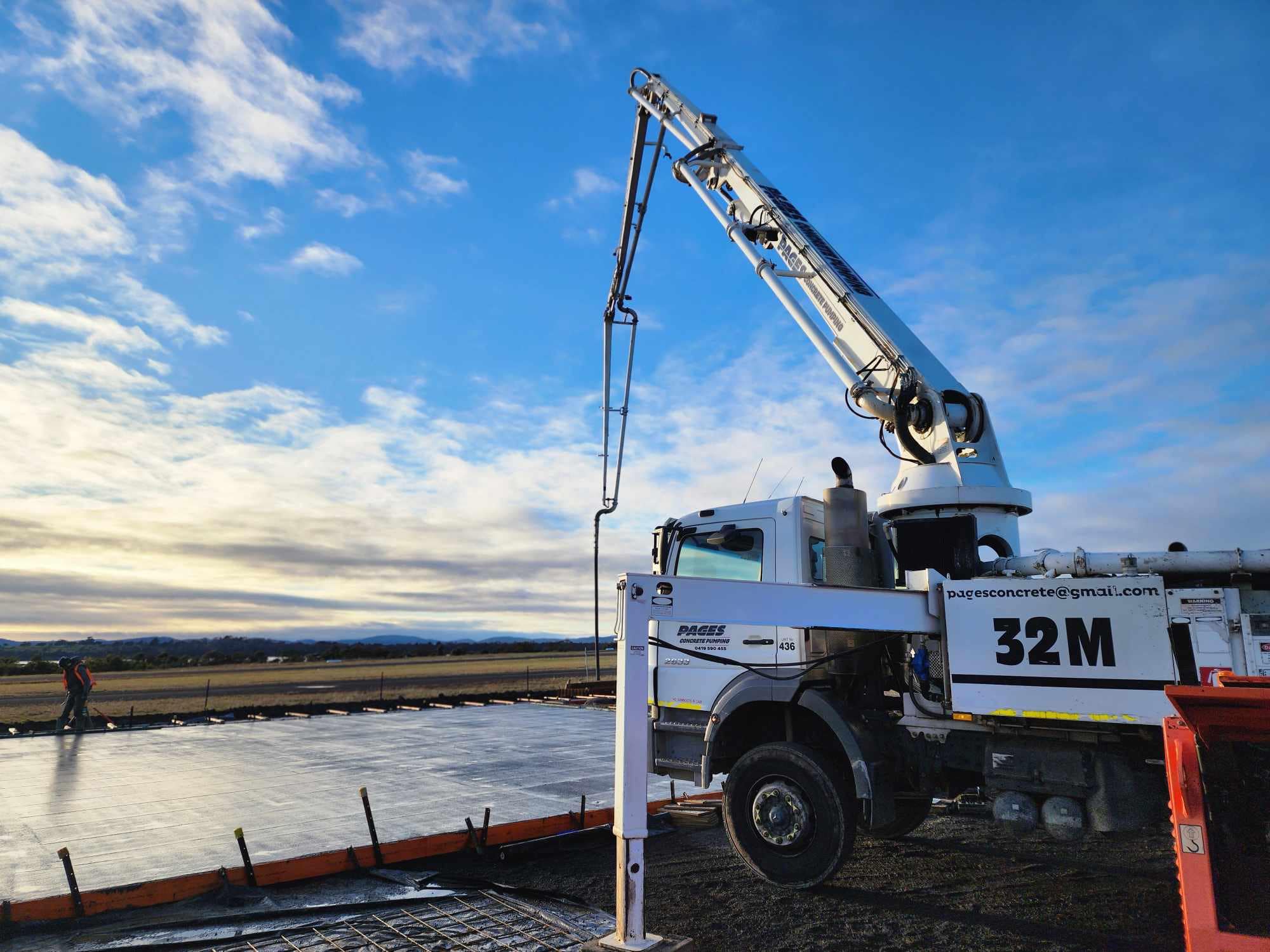 Page's 32m boom pump truck on a large commercial slab pour at sunrise, Southern Tasmania
